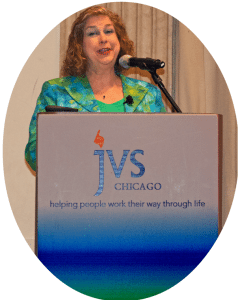 Image of Debra Ruh Standing behind a podium Speaking