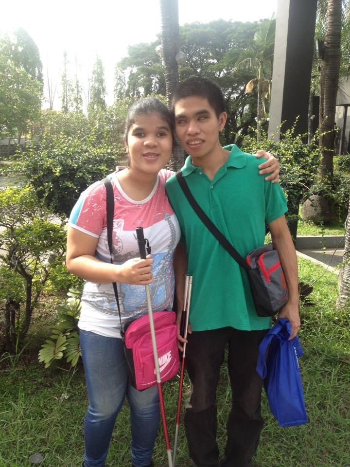 Two friends posing for a picture. 